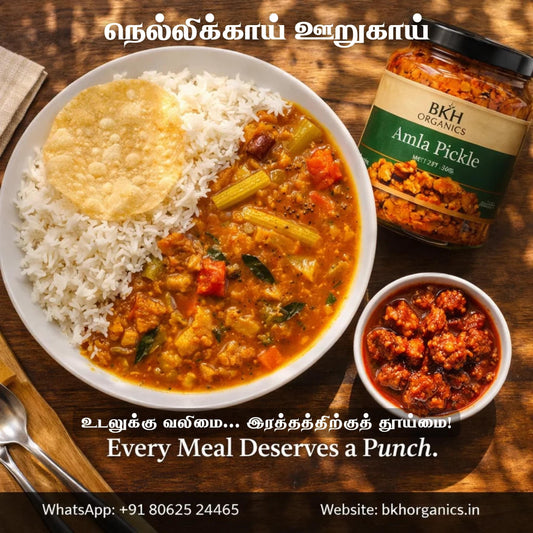 Curd rice with vegetables, amla pickle, and amla pickle jar on a wooden table.