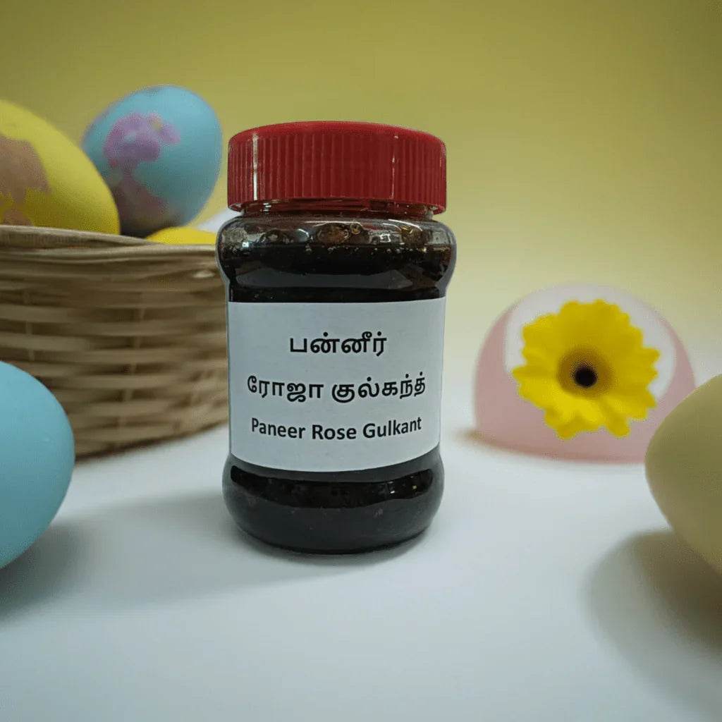 Bottle of Paneer Rose Gulkant with a red cap on a white surface with decorative eggs and flowers in the background. Rose Gulkandh 250g - BKH Organics
