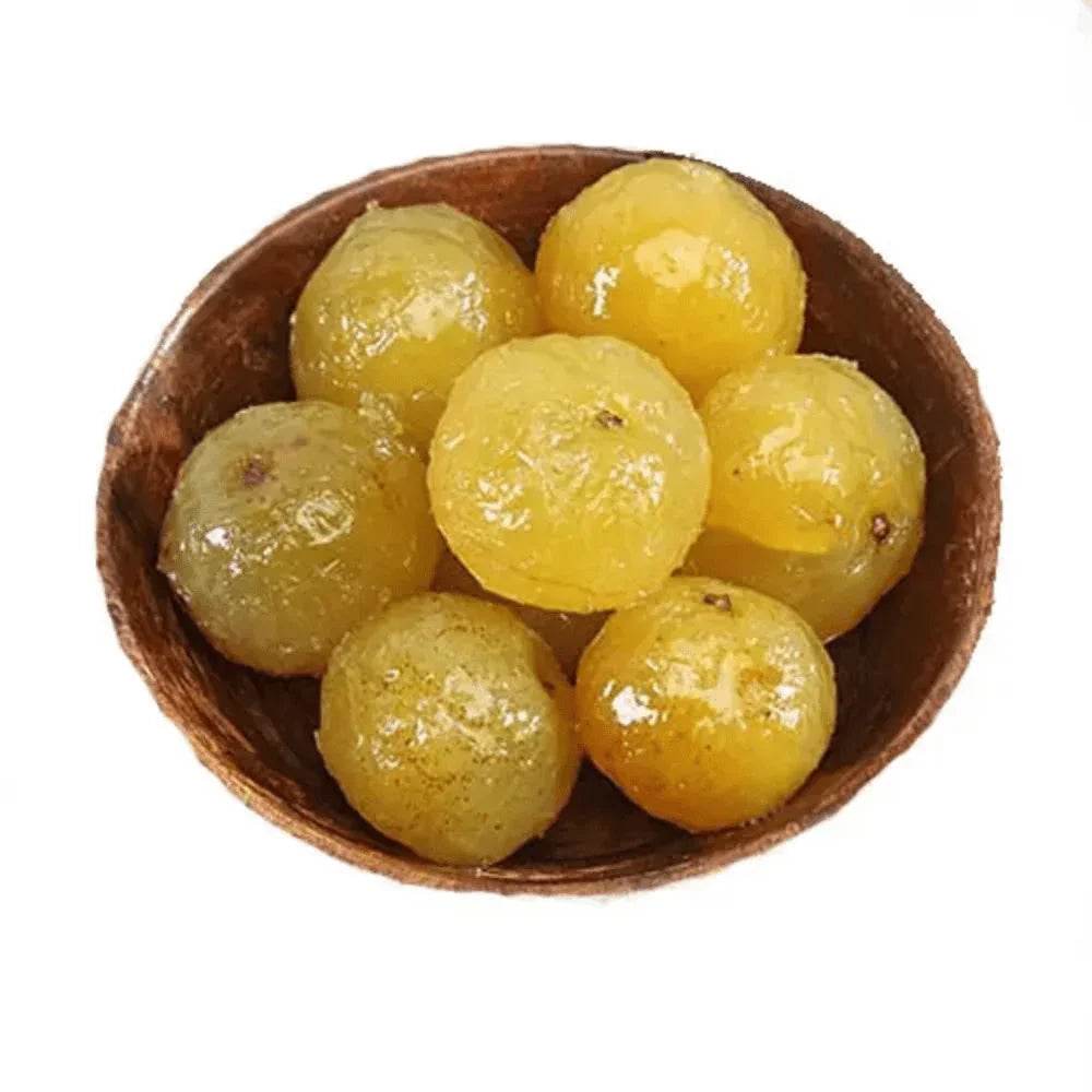 Wooden bowl filled with yellow grapes on a white background