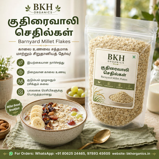 Barnyard Millet Flakes by BKH Organics in a clear stand-up pouch, shown beside a bowl of prepared oatmeal with banana, raisins, and nuts on a green cloth. The left side includes product information text in Tamil and English, and the background is a softly blurred kitchen scene. குதிரைவாலி செதில்கள்