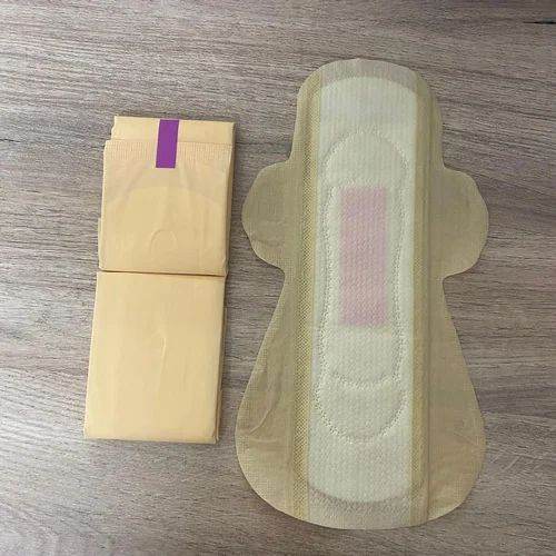 Menstrual pad and its packaging on a wooden surface. Bamboo Sanitary Napkins 14pc - BKH Organics