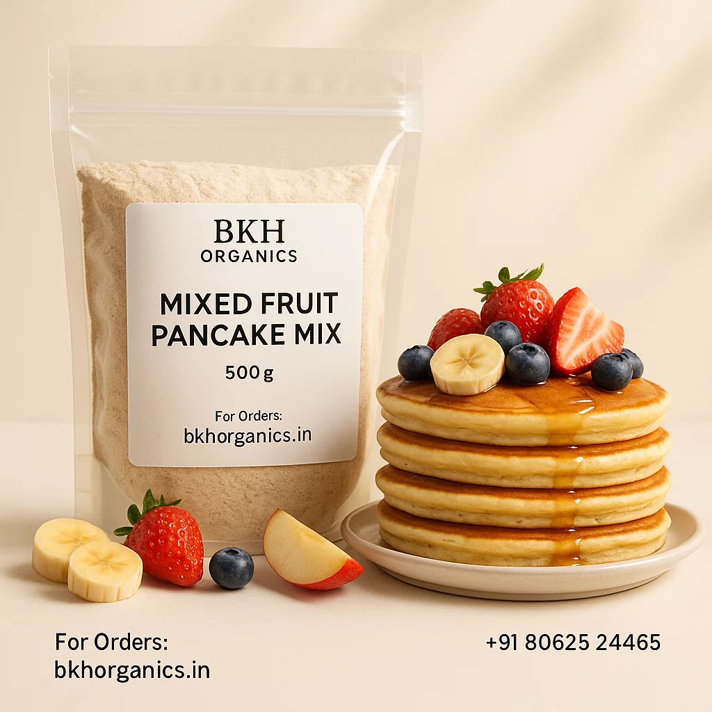 BKH Organics mixed fruit pancake mix package with a stack of pancakes topped with berries on a beige background.