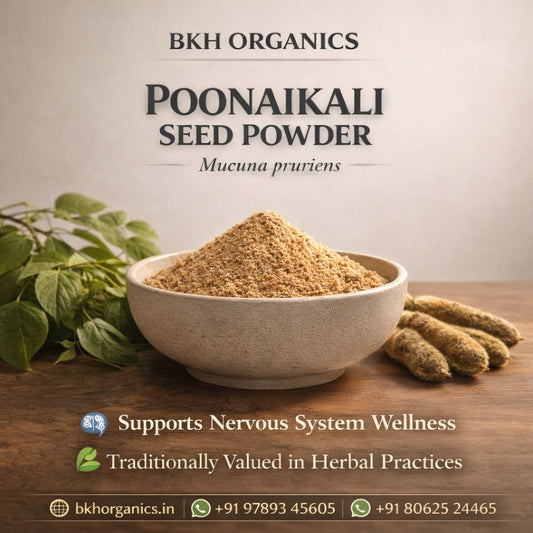 Bowl of Poonaikali seed powder with leaves and seeds on a wooden surface, branded as BKH Organics.