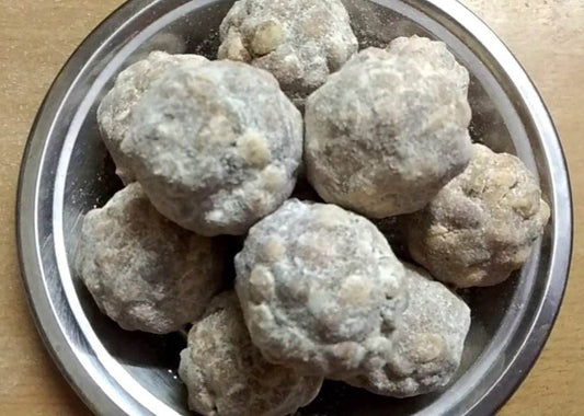 Frozen meatballs in a metal bowl on a wooden surface. Porula Urundai (Millets) 4pcs - BKH Organics