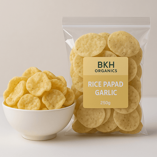 Rice papad garlic in a clear package with a yellow label and a bowl of rice papads on a light background.