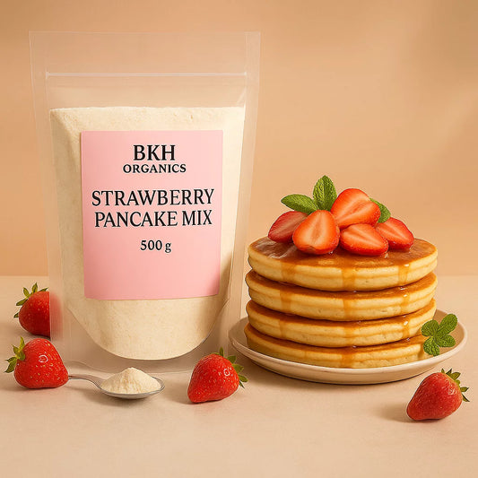 BKH Organics strawberry pancake mix with a stack of pancakes and strawberries on a beige background