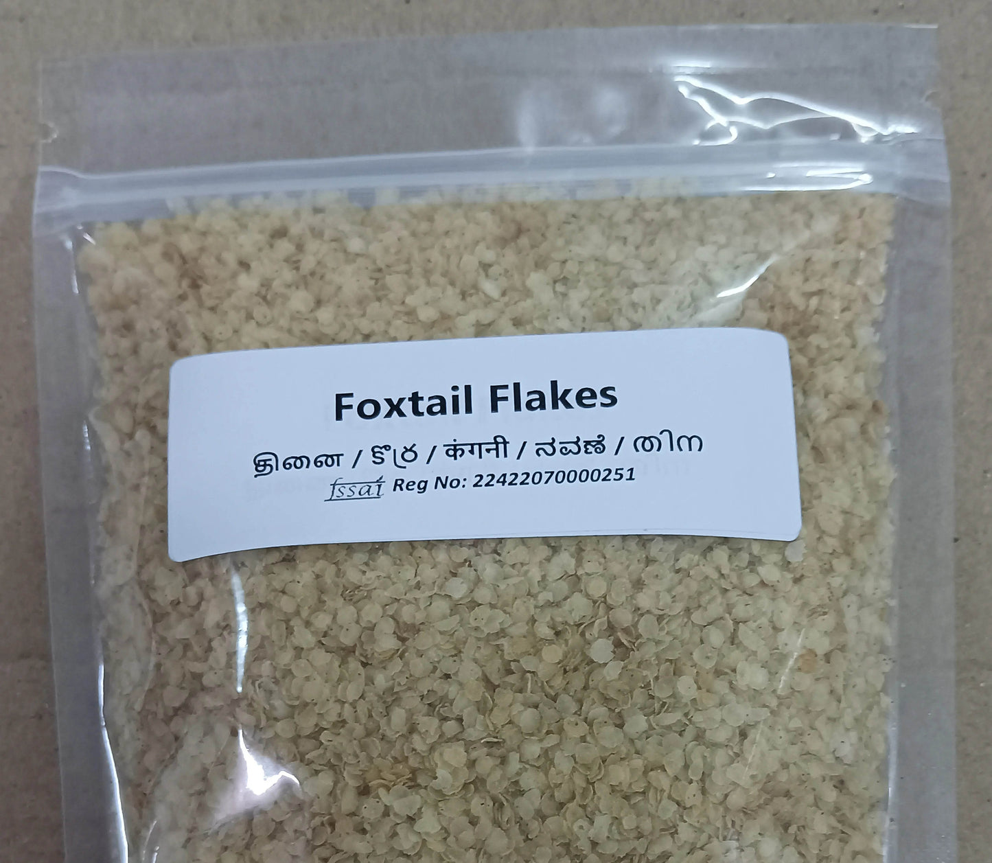 Package of Foxtail Flakes with a label on a beige background. Thinai Flakes (Foxtail) - BKH Organics