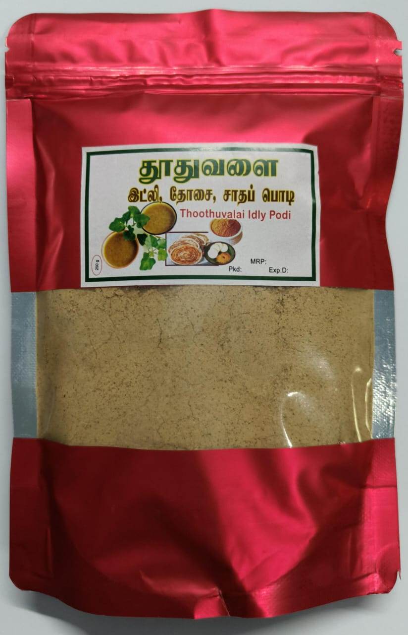 Red packaging of Thoduthvalai Idly Podi with a label on a gray background
