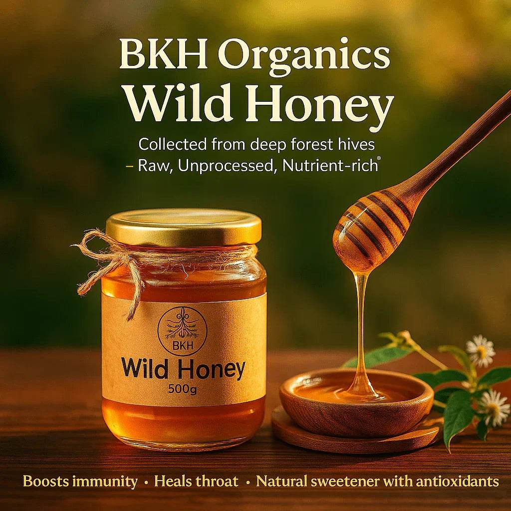 BKH Organics Wild Honey jar with a wooden dipper on a wooden surface, surrounded by greenery. Wild Honey 500g - BKH Organics