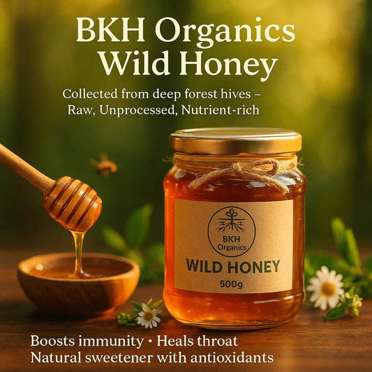 BKH Organics Wild Honey jar with honey dipper and flowers on a wooden surface Wild Honey 500g - BKH Organics