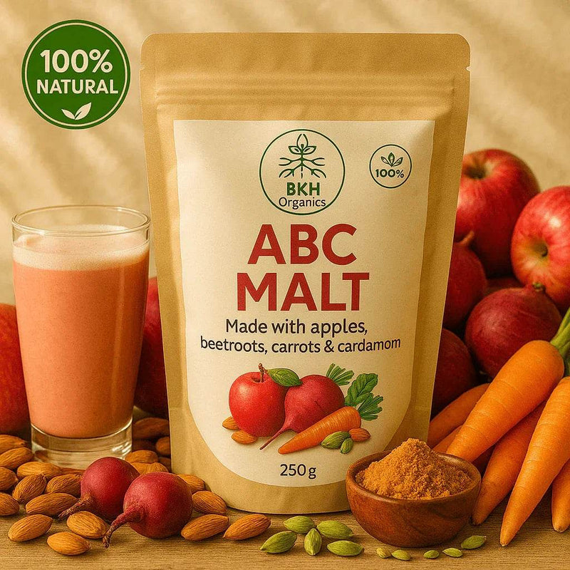 BKH Organics ABC Malt package with a glass of juice, fruits, and vegetables on a wooden surface.