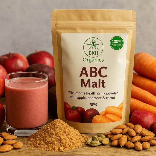BKH Organics ABC Malt package with a smoothie, fruits, and nuts on a wooden surface.