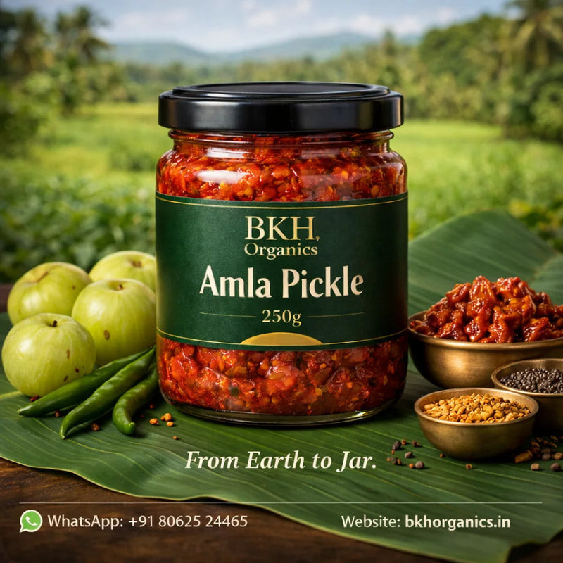 Jar of BKH Organics Amla Pickle with green apples and leaves on a natural background