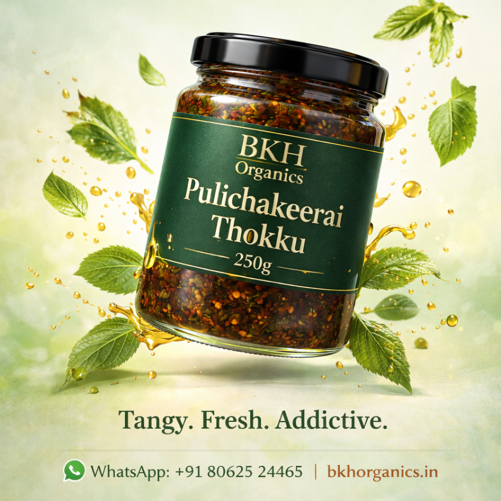 Jar of BKH Organics Pulichakeerai Thokku with green leaves on a light background