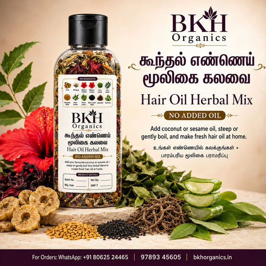 A bottle of BKH Organics Hair Oil Herbal Mix displayed on a styled background with ingredients like sliced cucumber, dried herbs, and a red flower. The image includes English and Tamil text detailing the product's benefits.