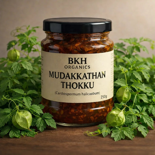 Jar of BKH Organics Mudakkathan Thokku with green plants on a wooden surface