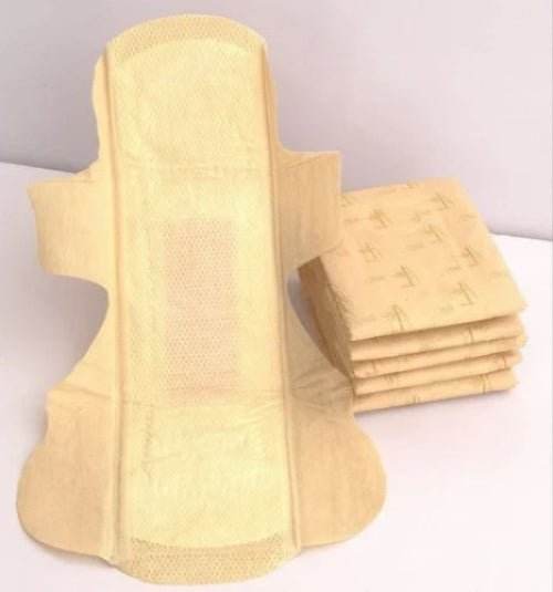 Stack of yellow sanitary pads on a white background. Bamboo Sanitary Napkins 14pc - BKH Organics 