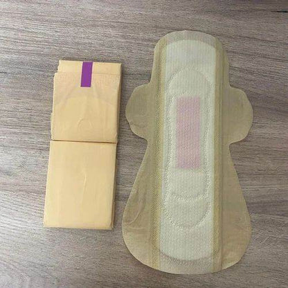 Menstrual pad and its packaging on a wooden surface. Bamboo Sanitary Napkins 14pc - BKH Organics