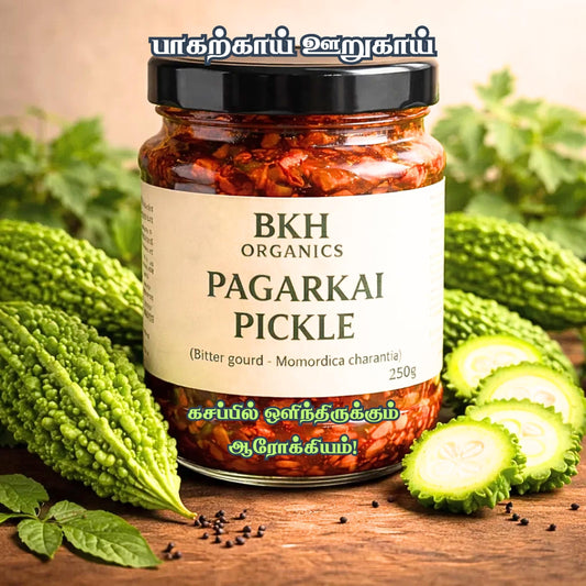 BKH Organics Pagarkai Pickle jar with bitter gourds on a wooden surface