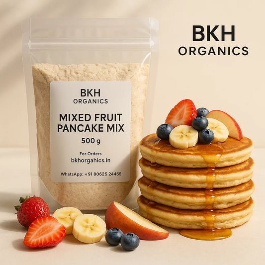 BKH Organics mixed fruit pancake mix with a stack of pancakes and fresh fruits on a beige background
