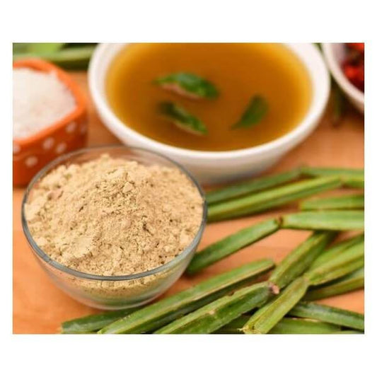 Bowl of powder, green leaves, and a bowl of soup on a wooden surface. Pirandai Herbal Powder 100g - BKH Organics