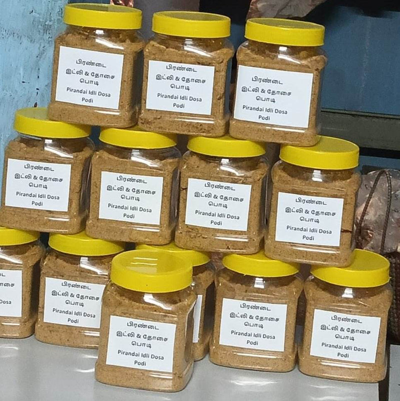 Jars of Pirandal Idli Dosa Podi with yellow lids and labels on a blue background, Pirandai idly & Dosa Podi 250g - BKH Organics