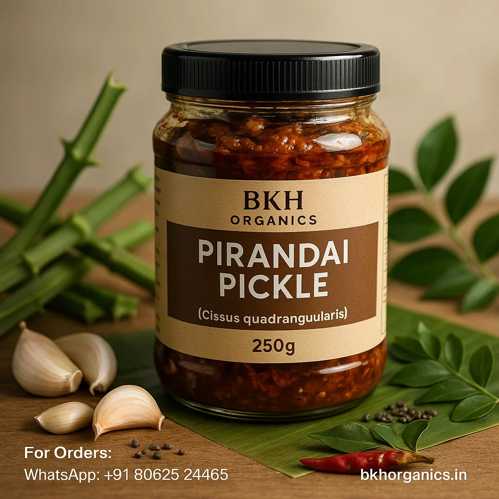 Jar of BKH Organics Pirandai Pickle with ingredients on a wooden surface, Adamant Creeper