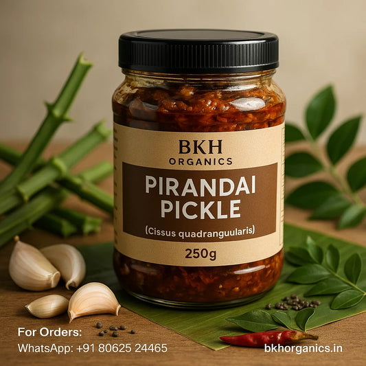 Jar of BKH Organics Pirandai Pickle with ingredients on a wooden surface, Adamant Creeper