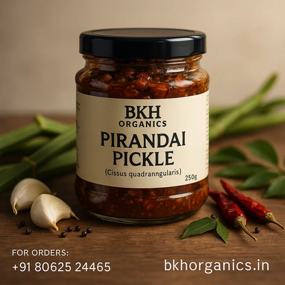 Jar of BKH Organics Pirandai Pickle with ingredients on a wooden surface, Adamant Creeper