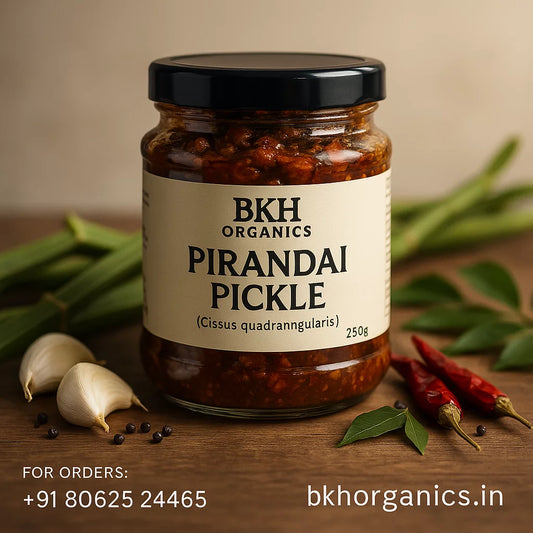 Jar of BKH Organics Pirandai Pickle with ingredients on a wooden surface, Adamant Creeper