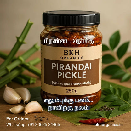 Jar of BKH Organics Pirandai Pickle with ingredients on a wooden surface