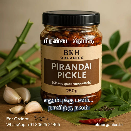Jar of BKH Organics Pirandai Pickle with ingredients on a wooden surface