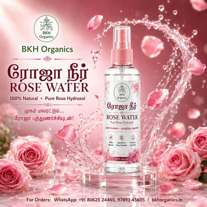 A bottle of BKH Organics Rose Water Pure Rose Hydrosol centered on a pink promotional background with rose petals, roses, and a water splash. The bottle is clear with pink spray top and pink floral graphics on the label.