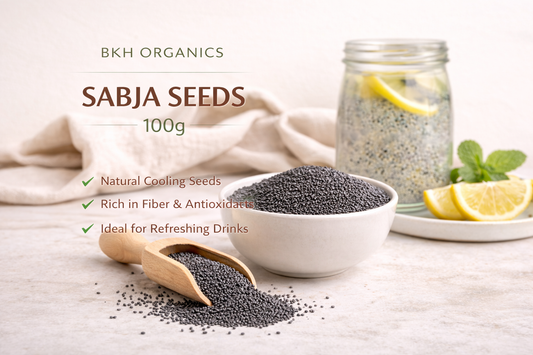 Bowl of sabja seeds with a wooden scoop on a light surface, featuring BKH Organics branding.