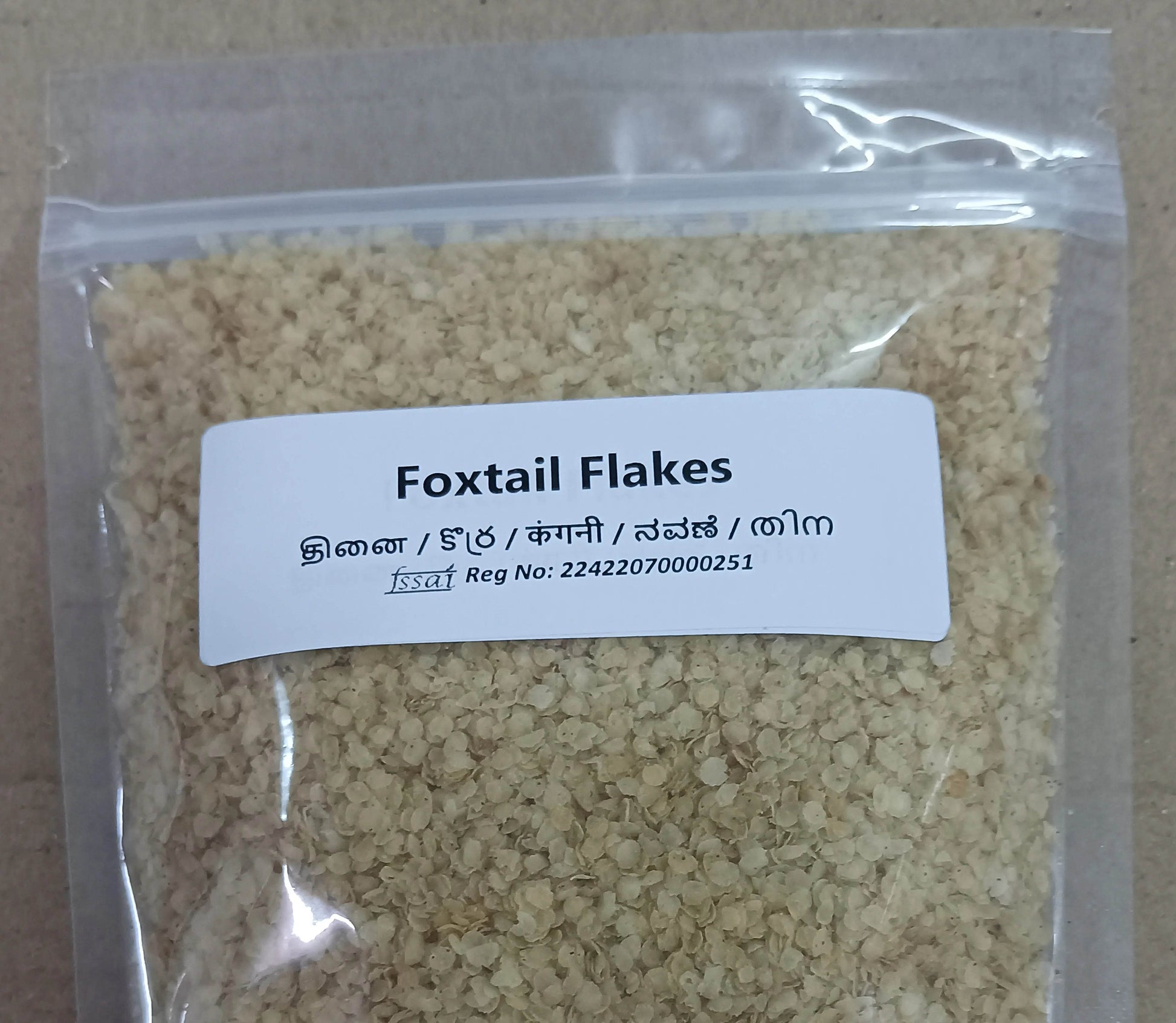 Package of Foxtail Flakes with a label on a beige background. Thinai Flakes (Foxtail) - BKH Organics