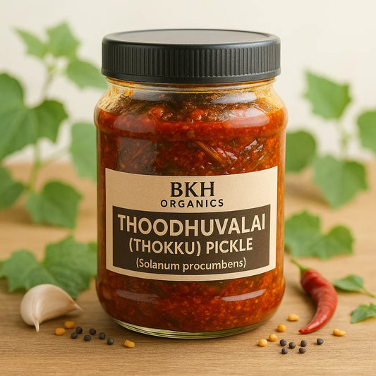 Jar of BKH Organics Thoodhuvalai (Thokku) Pickle with ingredients on a wooden surface, Solanum procumbens