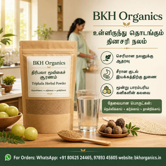 A promotional product image for BKH Organics Triphala Herbal Powder. The foreground shows a kraft paper pouch of the powder, a glass of water, a wooden spoon with powder, and whole fruits on a table.