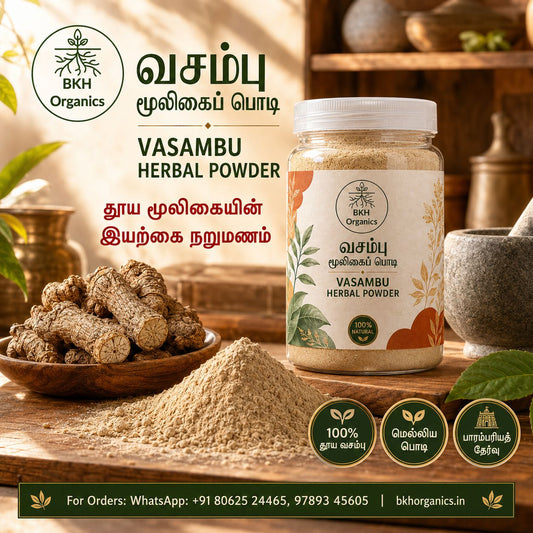 A jar of BKH Organics Vasambu Herbal Powder displayed on a rustic wooden table next to a bowl of fresh turmeric roots and loose powder, with promotional text and icons in Tamil and English.